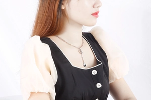 Silver letter necklace with U-shaped pendant on female model, minimalist style