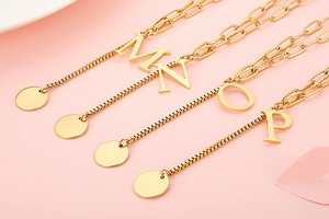 Detail of gold letter necklaces M, N, O, P with stylish dual-texture linked chains