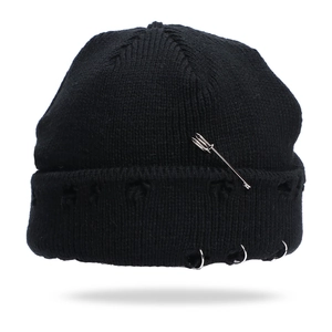 Distressed black knit beanie featuring silver metal rings and safety pin streetwear style