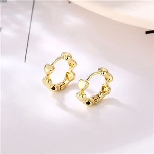 Minimalist gold heart-shaped hoop earrings featuring a series of linked hearts in brass