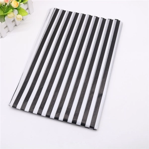Close-up of lightweight black and white striped wrapping paper sheets for gift packaging
