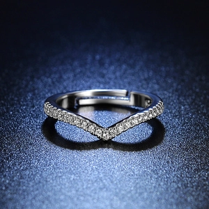 Detailed view of V-shaped adjustable ring with pavé-set diamonds on a starlight surface