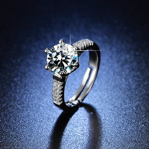Macro shot of silver six-prong adjustable ring with a brilliant round diamond simulant