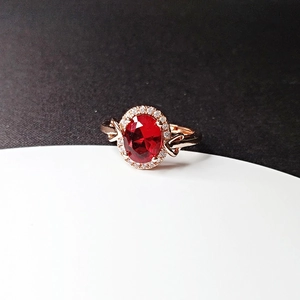 Elegant 18k rose gold plated ring with oval red ruby crystal and halo diamond accents