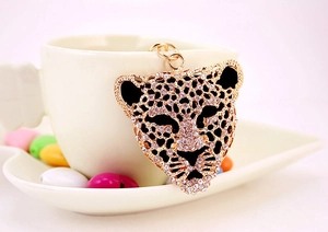Detail of crystal leopard head keychain with rhinestones and gold plating on cup edge