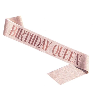 Close-up of rose gold glitter birthday queen sash with elegant lettering for party