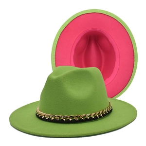 Detail of green fedora hat with fuchsia lining and elegant gold metal chain trim