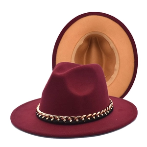 Detail of burgundy wool fedora featuring golden chain trim and khaki inner lining