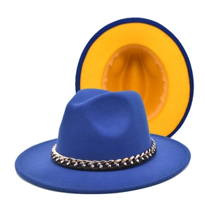 Detail of royal blue fedora hat with gold chain and contrasting yellow lining