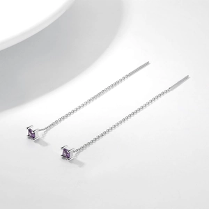 Detail of S925 silver thread earrings featuring small square-cut purple gemstones