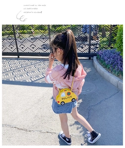 Detail shot of a yellow car-shaped kids crossbody bag with POLICE logo and star detail