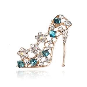 Macro shot of high heel brooch with blue crystals and sparkling white rhinestones