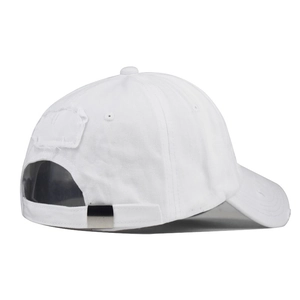 Close-up of distressed white cotton baseball cap with vintage worn-out brim and metal buckle