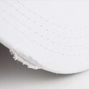 Macro shot of white washed cotton baseball cap with distressed brim and stitching details