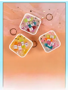 Miniature colorful cocktail bucket keychain with tiny bottles and clear faux ice cubes