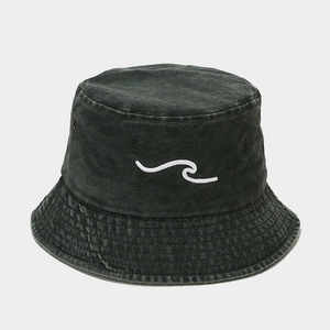 Detail of grey washed cotton bucket hat featuring 3D wave embroidery and side metal eyelets