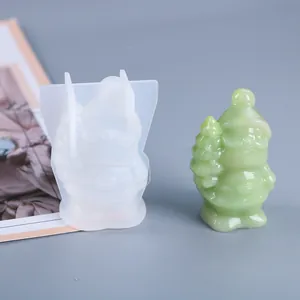 Detailed DIY silicone mold with finished green resin Santa Claus holding a Christmas tree