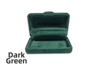 Detail view of a dark green velvet jewelry box with a curved slot for watches or bracelets