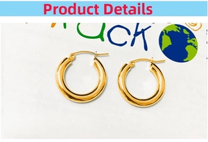 Detailed macro view of high-polished 18k gold-plated chunky stainless steel hoop earrings