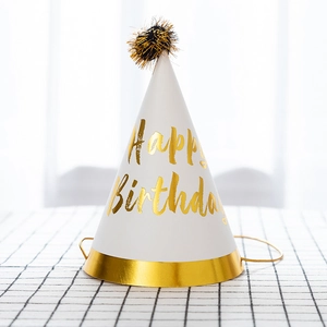 White and gold Happy Birthday cone hat with a black pompom for party decorations