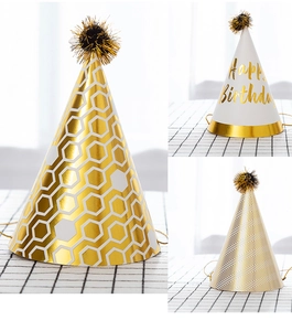 Detailed view of three cone party hats featuring gold foil patterns and fuzzy pom-poms