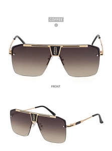 Close-up of stylish large square sunglasses with gold metal frames and coffee gradient lenses