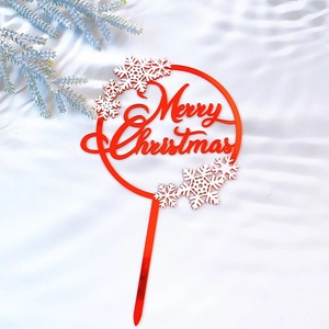 Red round Merry Christmas cake topper with white snowflake motifs on silk background