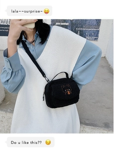 Detail of black faux shearling bag with cute bear embroidery and adjustable strap