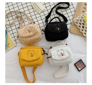 Detailed flat lay of lamb wool crossbody bags featuring cute bear embroidery in four colors