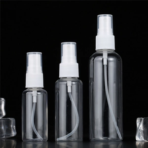 Three transparent PET plastic spray bottles in various sizes on reflective black background