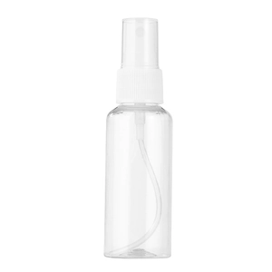 Close-up of clear PET plastic spray bottle with white nozzle on white background