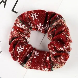 Macro shot of 10cm Christmas knit scrunchie with red wool and white snowflake pattern