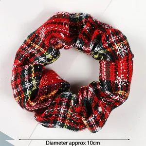 Detail of Christmas plaid scrunchie with snowflake prints, showing 10cm diameter size