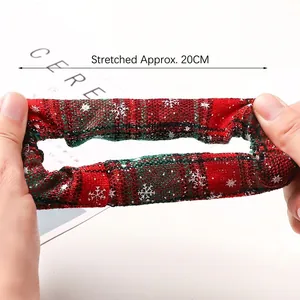 Red and green Christmas plaid scrunchie with snowflakes, shown stretched to 20cm