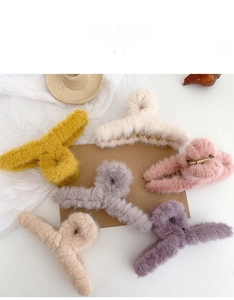 Flat lay of soft plush hair claws in various warm colors for winter styling