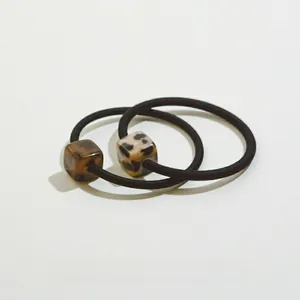 Detail of high-elastic hair ties with leopard print and tortoiseshell resin square beads