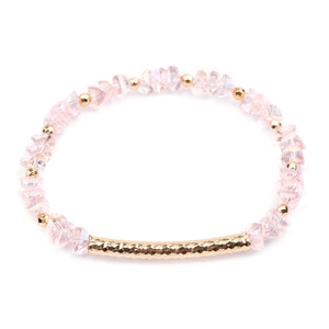 Close-up of pink crystal beads and hammered gold metal tube on a handmade bracelet