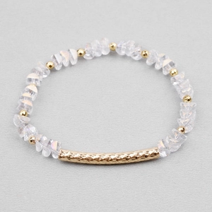 Detailed shot of beaded bracelet with faceted crystal beads and textured gold tube charm