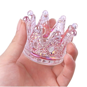Close-up of a glass crown nail crystal cup with iridescent glitter finish for manicure