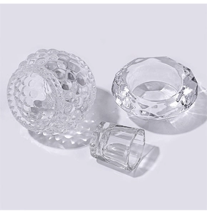 Detailed view of three faceted glass containers with honeycomb textures for nail liquid