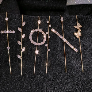 Detailed view of six gold-plated ear cuffs featuring cubic zirconia in various shapes