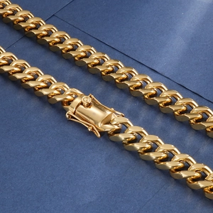 Macro shot of a polished golden Cuban link chain with a secure double-lock box clasp