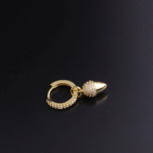 Detailed close-up of golden acorn drop earring with sparkling zircon pavé setting