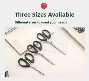 Three sizes of black stainless steel household scissors displayed with office stationery