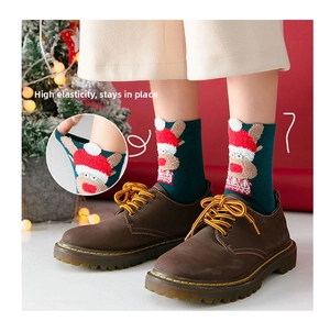 Detail of green Christmas sock with reindeer embroidery and elastic ribbed cuff