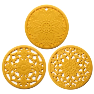 Three yellow silicone placemats with hollow floral patterns and heat insulation