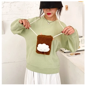 Close-up of brown plush phone bag featuring a 3D white cloud pattern on a model