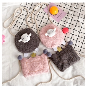 Close-up of plush cartoon lamb and crown kids bags with lamb wool texture and straps