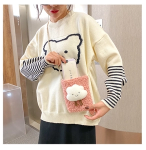 Detail showing plush pink faux fur crossbody phone bag with cloud and small legs deco