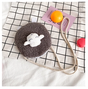 Detailed view of the plush lamb wool texture and cute cartoon embroidery on child crossbody bag
